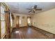 Spacious living room with wood floors, ornate curtains, and ceiling fan at 208 N School St, Mount Gilead, NC 27306
