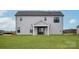 Rear exterior view of a home featuring light gray siding, a covered patio area, and a well-maintained lawn at 2092 Fordhill St, Rock Hill, SC 29732