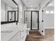 A modern bathroom features double sinks, a walk-in shower with black trim, and modern fixtures at 2092 Fordhill St, Rock Hill, SC 29732