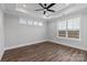 A serene bedroom features a tray ceiling, a ceiling fan, and a window with natural light at 2092 Fordhill St, Rock Hill, SC 29732
