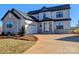 Charming two-story home with a combination of light gray siding and stone accents, complemented by a two-car garage at 2092 Fordhill St, Rock Hill, SC 29732