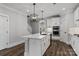 Elegant kitchen featuring a central island with modern pendant lighting, white cabinetry, and stainless steel appliances at 2092 Fordhill St, Rock Hill, SC 29732