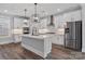 Modern kitchen with white cabinets, a large island, stainless steel appliances, and contemporary pendant lighting fixtures at 2092 Fordhill St, Rock Hill, SC 29732