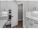 A modern kitchen featuring stainless steel appliances, white cabinets, and a pantry with metal shelving at 2092 Fordhill St, Rock Hill, SC 29732
