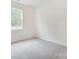 This bedroom features comfortable carpet and a window with a view of the outdoors at 2233 Tabor Rd # 586, Sherrills Ford, NC 28673
