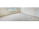 Bedroom featuring neutral colored carpeting and baseboards, natural light from a window, and white door at 2233 Tabor Rd # 586, Sherrills Ford, NC 28673