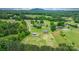 Breathtaking aerial view showcasing the extensive land, multiple buildings, and serene surroundings of the property at 2448 Moss Farm Rd, Hickory, NC 28602