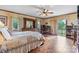 Bright bedroom featuring hardwood floors, a ceiling fan, and sliding door access to the outdoors at 2448 Moss Farm Rd, Hickory, NC 28602