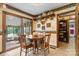 Cozy dining area with wood table, chairs, built-in shelving, and access to the sunroom at 2448 Moss Farm Rd, Hickory, NC 28602