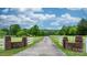 Long private driveway leading to a beautiful home with a gated entrance, surrounded by lush greenery at 2448 Moss Farm Rd, Hickory, NC 28602