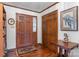 Inviting entryway featuring hardwood floors, wood door, closet, and a charming table with decor at 2448 Moss Farm Rd, Hickory, NC 28602