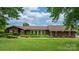 Lovely brick home with lush green lawn and colorful flowerbeds enhancing its curb appeal at 2448 Moss Farm Rd, Hickory, NC 28602