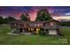 Back exterior of a brick home with a screened porch and walkout basement at 2448 Moss Farm Rd, Hickory, NC 28602