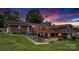 Brick home with a sunroom, deck, landscaped yard, and patio, perfect for outdoor entertaining at sunset at 2448 Moss Farm Rd, Hickory, NC 28602