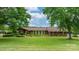 Lovely brick home with lush green lawn and mature trees enhancing its curb appeal at 2448 Moss Farm Rd, Hickory, NC 28602