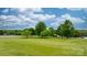 Expansive front yard view with a white fence under a bright, cloudy sky at 2448 Moss Farm Rd, Hickory, NC 28602