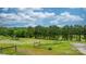 Picturesque view of a front yard featuring well-maintained grass, mature trees, and a rustic fence at 2448 Moss Farm Rd, Hickory, NC 28602