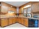 Traditional kitchen with wood cabinetry, granite countertops, tile backsplash, and modern appliances at 2448 Moss Farm Rd, Hickory, NC 28602