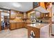 Traditional kitchen with wood cabinetry, granite countertops, tile backsplash, and breakfast bar at 2448 Moss Farm Rd, Hickory, NC 28602