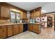Traditional kitchen with wood cabinets, stone countertops, tile floor, and a view to the dining area at 2448 Moss Farm Rd, Hickory, NC 28602