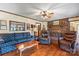 Inviting living room with hardwood floors, comfortable seating, and a brick fireplace, perfect for relaxation at 2448 Moss Farm Rd, Hickory, NC 28602