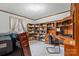 Home office featuring custom wood shelving, natural light, and a comfortable workspace at 2448 Moss Farm Rd, Hickory, NC 28602
