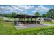 Functional shed surrounded by lush greenery and white fencing, perfect for outdoor storage or equipment at 2448 Moss Farm Rd, Hickory, NC 28602