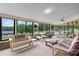 Bright sunroom with expansive windows overlooking a scenic view, complete with comfortable seating at 2448 Moss Farm Rd, Hickory, NC 28602