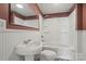 Bathroom features a white sink, toilet, and shower with a white tile surround at 24515 Saint Martin Rd, Albemarle, NC 28001