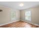 Cozy bedroom with wood-look floors, base trim, and natural light at 24515 Saint Martin Rd, Albemarle, NC 28001