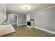 Eat-in kitchen includes an electric range, grey walls and vintage light fixture at 24515 Saint Martin Rd, Albemarle, NC 28001