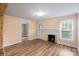 Living room with wood-look floors, fireplace, and entry door at 24515 Saint Martin Rd, Albemarle, NC 28001