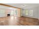 Open-concept living area with hardwood floors, fireplace, and natural light at 24515 Saint Martin Rd, Albemarle, NC 28001