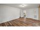 Living room features hardwood floors, white walls, and a view into the kitchen at 24515 Saint Martin Rd, Albemarle, NC 28001