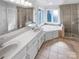 Luxurious bathroom featuring a soaking tub, double vanity, and glass-enclosed shower at 2532 Steeplechase Rd, Gastonia, NC 28056