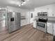 Spacious kitchen features stainless steel appliances, granite countertops, and sleek white cabinetry at 2532 Steeplechase Rd, Gastonia, NC 28056