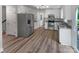 Spacious kitchen with stainless steel appliances, granite countertops, white cabinetry, and modern flooring at 2532 Steeplechase Rd, Gastonia, NC 28056
