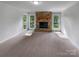 Bright, spacious living room featuring a stone fireplace and large windows offering ample natural light at 2532 Steeplechase Rd, Gastonia, NC 28056