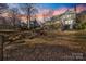 Expansive backyard with mature trees, deck, screened-in porch, and beautiful sunset views at 2702 Oxborough Dr, Matthews, NC 28105