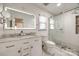 Bright bathroom boasts a dual sink vanity with an LED mirror and a glass-enclosed shower at 2702 Oxborough Dr, Matthews, NC 28105