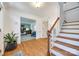 Inviting foyer with hardwood floors, a staircase, and a view into a well-lit home office at 2702 Oxborough Dr, Matthews, NC 28105