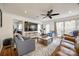 Comfortable living room featuring hardwood floors, ceiling fan and plenty of natural light from the windows at 2702 Oxborough Dr, Matthews, NC 28105