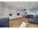 Spacious living room with built-in shelving, hardwood floors and a comfortable leather sectional sofa at 2702 Oxborough Dr, Matthews, NC 28105