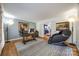 Bright and spacious home office with hardwood floors, a large desk, and a comfortable massage chair at 2702 Oxborough Dr, Matthews, NC 28105