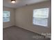 Bright bedroom with neutral carpet, two windows, and natural light at 2716 Rea Rd, Charlotte, NC 28226