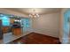Open dining room with wood floors is open to the kitchen with a center island and stainless steel appliances at 2716 Rea Rd, Charlotte, NC 28226