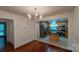 Open dining room with wood floors flows into the kitchen with a center island and stainless steel appliances at 2716 Rea Rd, Charlotte, NC 28226