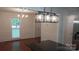 Dining room with modern lighting and a view into the updated kitchen area at 2716 Rea Rd, Charlotte, NC 28226