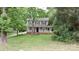 Charming two-story home with a welcoming front porch nestled among mature trees and lush greenery at 2716 Rea Rd, Charlotte, NC 28226