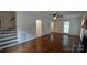 Living room with hardwood floors, staircase, and access to multiple rooms at 2716 Rea Rd, Charlotte, NC 28226